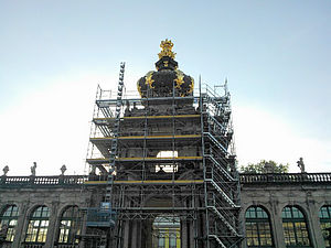 An entrance portal of the Dresden Zwinger is encased in a scaffolding