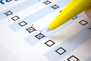 Close-up shot of a ball pen checking boxes in a questionnaire